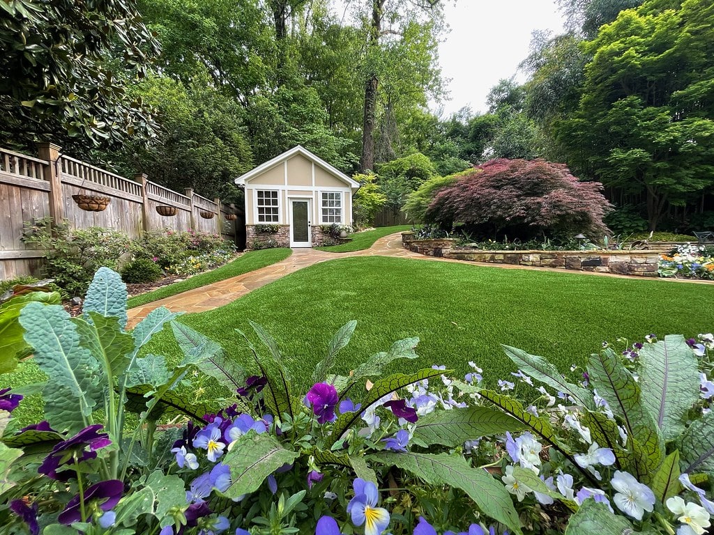 Backyard landscaping featuring ForeverLawn synthetic grass