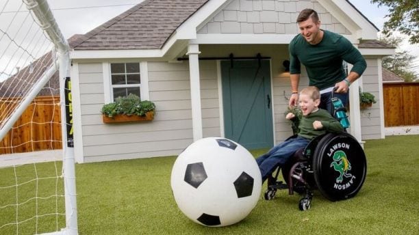 Tim Tebow playing soccer on ForeverLawn.